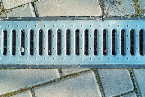 Static shot of storm drain in road Foto stock