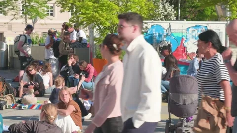 Static shot on sunny crowd relaxing in public square in Innsbruck Austria Stock Footage 335961802