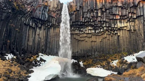 Static Shot of Svartifoss Waterfall with Ice and Basalt Columns, Iceland. Stock Footage 327673256