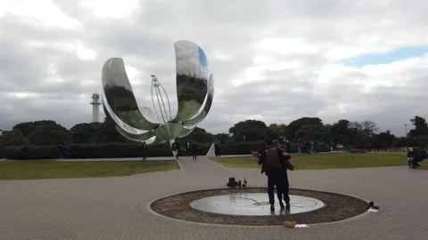 Static Shot of a Tango Couple Dancing Before Floralis Genérica Symbolizing Stock Footage 342296586