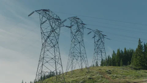 Static shot of three high tension power lines on a sunny day Stock Footage 233762219