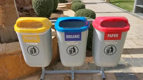 Static shot of three recycling bins labeled plastic organic and paper stand.. Stock Footage 329871085