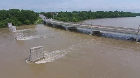 Static shot of traffic moving down hill and over bridge to cross river Stock Footage 53028315