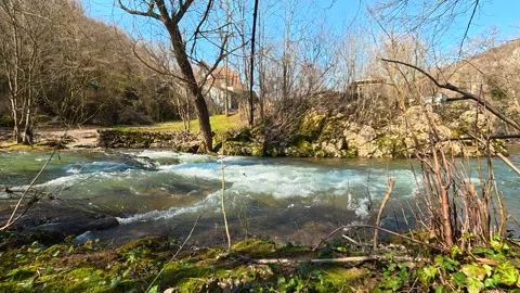Static Shot of Turquoise River With White Foam Over Rocks Video stock 330941700