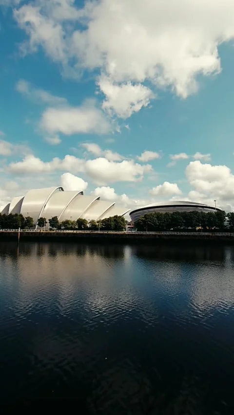 Static shot of two modern buildings next to the riverside - Vertical Video Stock Footage 200401117