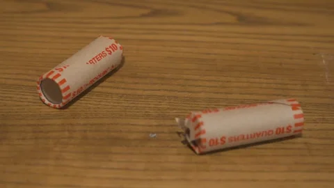 Static shot of two Rolls of American Quarters. Видео 333189741