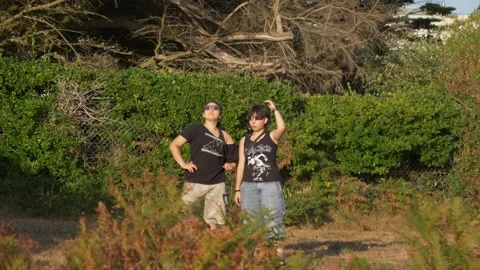 Static shot of two young women wearing eclipse glasses observing 2026 solar Stock Footage 346454774