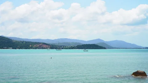 Static shot of a vibrant sea landscape with a boat and majestic mountains Stock Footage 236695870