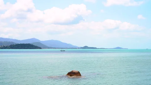 Static shot of a vibrant sea landscape with a boat and majestic mountains Stock Footage 236696030