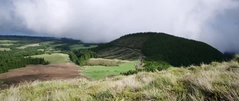 A static shot of a walking path at the lagoon, views of lush green hills Stock Footage 320976377
