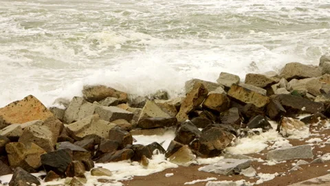 Static shot of waves crashing onto large coastal rocks in Japan on overcast day Stock Footage 321105305