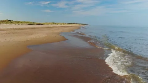 A static shot of waves moving onto a beach. Stock Footage 155309816