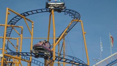 Static shot, of a wild mouse roller coaster, where a few blue and pink Video stock 102067362
