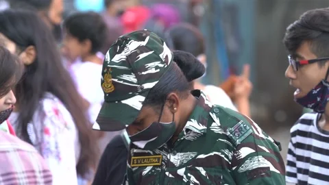 Static shot of a woman in a commando uniform in Janpath at New Delhi, India Stock Footage 166345173