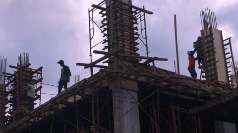 Static silhouettes of construction workers on a building at dusk Stock Footage 58127889