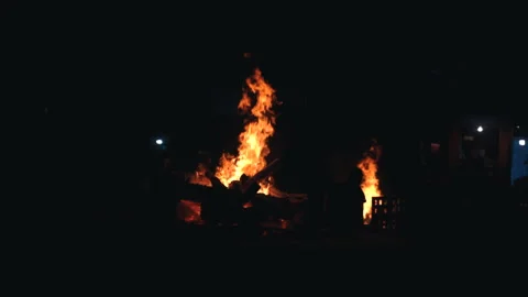 Static slow motion shot of burning funeral pyre fire on cremation ghat in Stock Footage 348108599