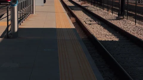 Static slow motion shot of empty transit platform with train shadow passing Stock Footage 333148359