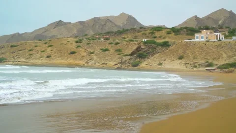 Static slow motion shot of the ocean with calm waves reaching the shore of a Stock Footage 284445245