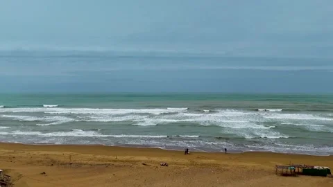 Static slow motion shot of the ocean with calm waves reaching the shore of a Stock Footage 284445373