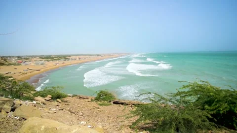 Static slow motion shot of the ocean with calm waves reaching the shore of a Stock Footage 284445411