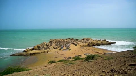 Static slow motion shot of the ocean with calm waves reaching the shore of a Stock Footage 284445413