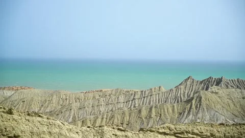 Static slow motion shot of the ocean with calm waves reaching the shore of a Stock Footage 284445655