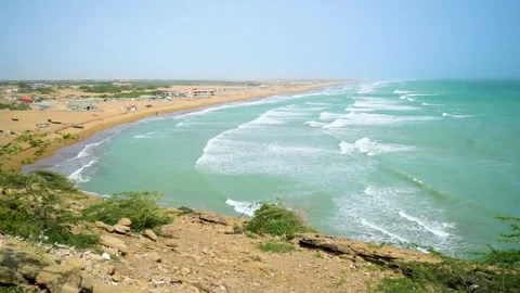 Static slow motion shot of the ocean with calm waves reaching the shore of a Stock Footage 284445748
