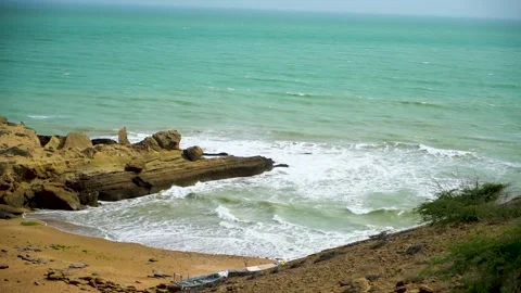 Static slow motion shot of the ocean with calm waves reaching the shore of a Stock Footage 284445967