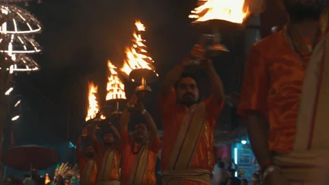 Static slow motion shot of priests performing Ganga Aarti with fire lamps in 스톡 동영상 347986514