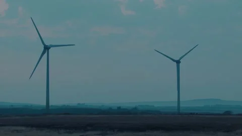 Static Slow Motion Shot of a Wind Farm at Dusk Stock Footage 196294480
