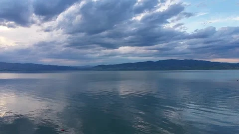 Static Sunset View of Blue Lake and Dramatic Rain Clouds Stock Footage 344997940