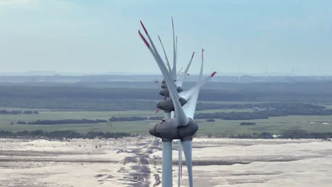 Static telephoto view Enercon wind turbine alignment row stacking effect Stock Footage 327539861
