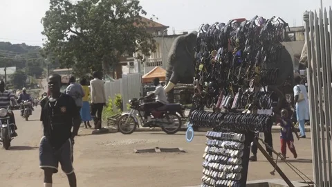 Static tight shot of sunglasses stand next to Ugandan market Stock Footage 81749111