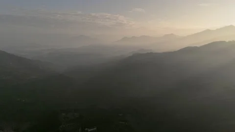 Static Time Lapse. Moody aerial drone shot of sun streaks over foggy mountain Video stock 185413837