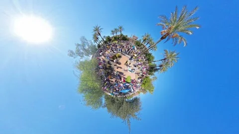 Static Tiny Planet View of Protesters Circling Plaza Under Tall Palm Tree 動画素材 322157619
