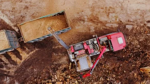 Static Top Down Biomass Processing - Wood Chipper Loading Truck With Chips Stock Footage 344079110