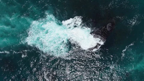 Static Top Down Drone Shot of Waves Crashing Over Ocean Rock Stock Footage 330318116