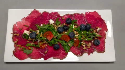 Static top down shot of delicious served carpaccio dinner plate with ingredients Video stock 146116821