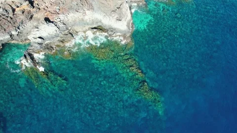 Static top view of the blue ocean near the rocky coast of El Hierro Stock Footage 230293938