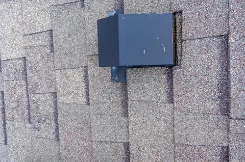 Static vent installed on a shingle roof for passive attic ventilation Foto stock