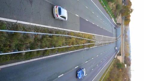 A static, vertical / 9:16 shot of light traffic flowing on motorway in the UK Stock Footage 143013905