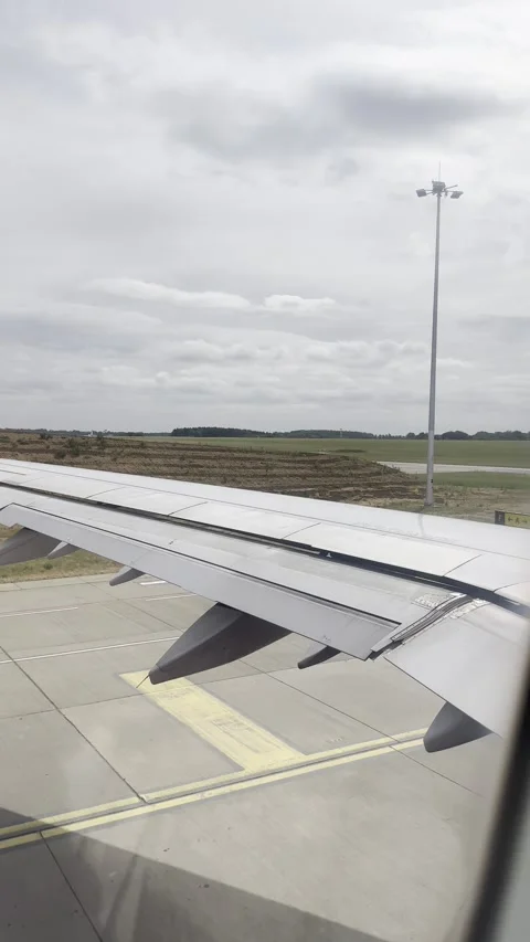 Static vertical shot of an airplane wing adjusting during landing approach Stock Footage 336494930