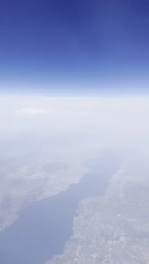 Static vertical shot of airplane wing flying over cyprus coast through haze Stock Footage 336506628