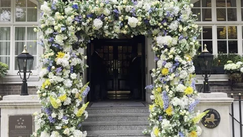Static vertical shot of beautiful floral arch around townhouse entrance door Stock Footage 336680202