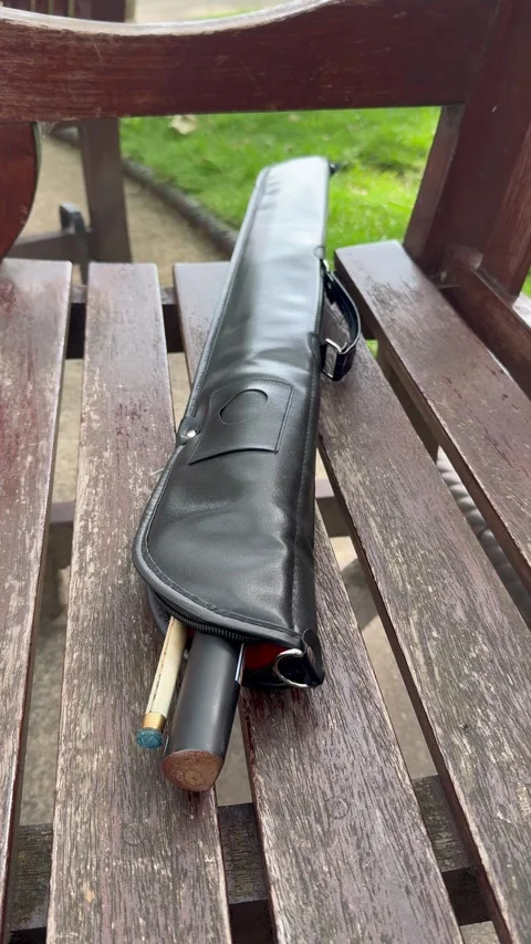 Static vertical shot of billiard cue stick in leather case on wooden bench Stock Footage 337183866