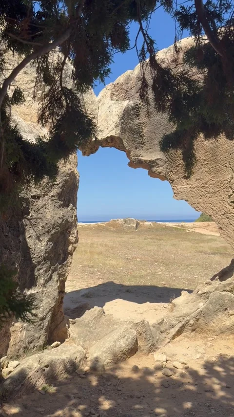 Static vertical shot of a natural stone archway near ancient ruins site Stock Footage 336333989