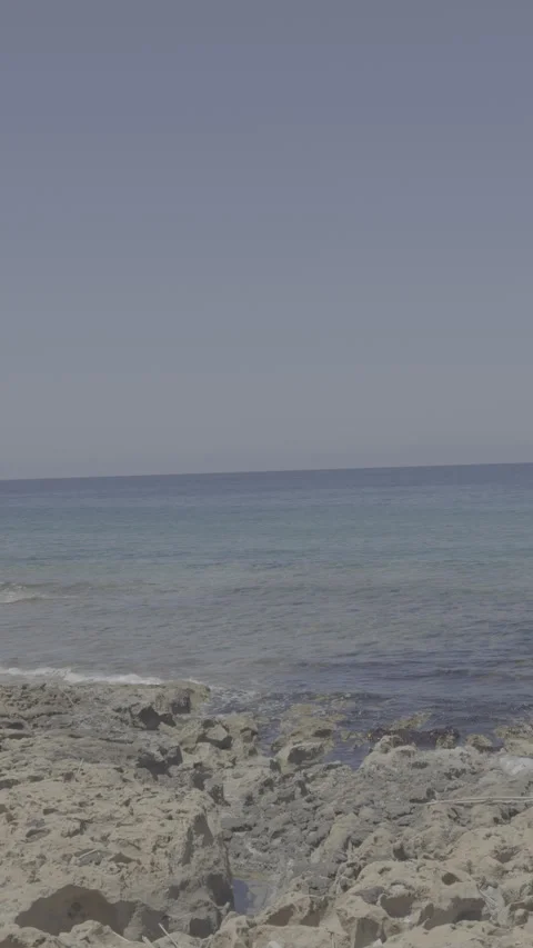 Static vertical shot of raw log footage of rocky coastline and sea in paphos Stock Footage 336638287