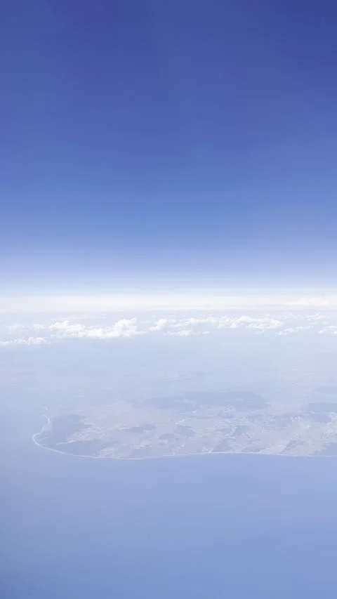 Static vertical shot of a scenic aerial coastline view from high altitude flight Stock Footage 336517724