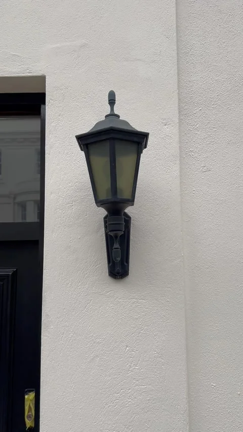 Static vertical shot of a traditional black wall lantern in london Video stock 336539001