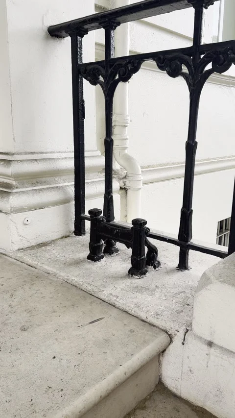Static vertical shot of vintage cast iron boot scraper on doorstep in London Stock Footage 336680027